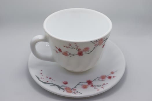 ceramic cup and plate closeup on white background