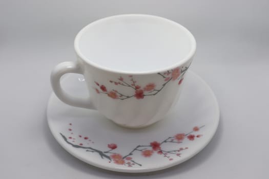ceramic cup and plate closeup on white background