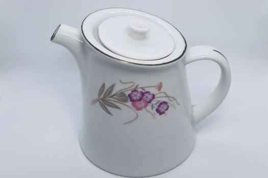 ceramic tea kettle closeup on white background