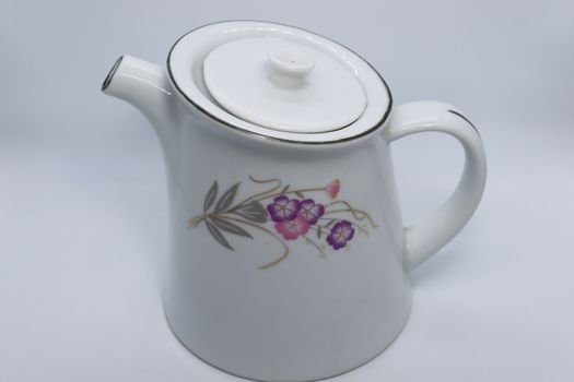 ceramic tea kettle closeup on white background