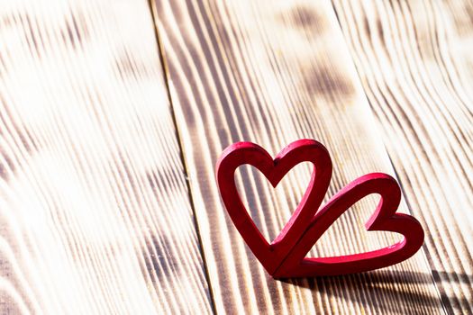 Two red wooden hearts symbol of love on wood background, Saint Valentine Day celebration