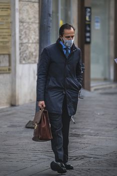 terni,italy november 24 2020:business man with medical mask and briefcase