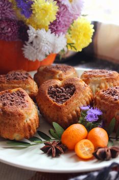 Homemade cakes with grated chocolate and decorated with tangerines