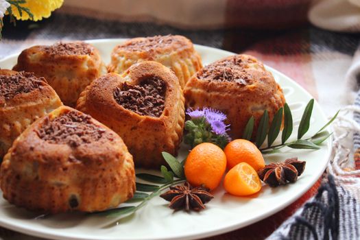 Heart shaped cookies decorated with grated chocolate and tangerines