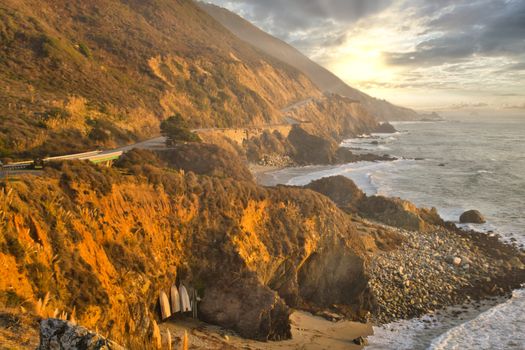 Big Sur coastal highway and landscape during golden hour sunset. Travel and Tourism.