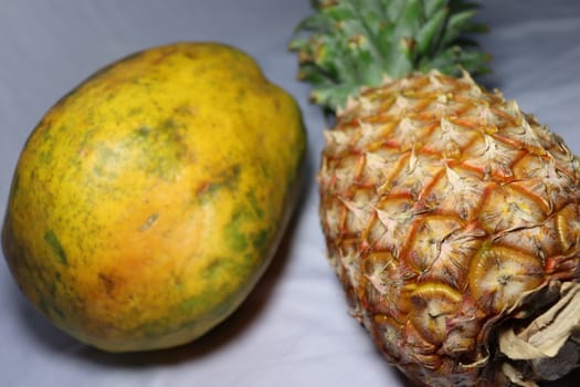 tasty healthy papaya and pineapple closeup