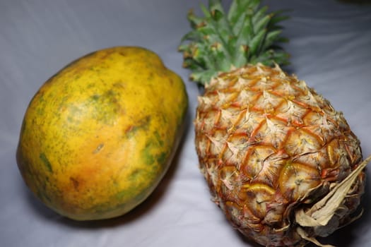 tasty healthy papaya and pineapple closeup