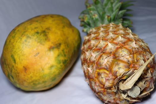 tasty healthy papaya and pineapple closeup