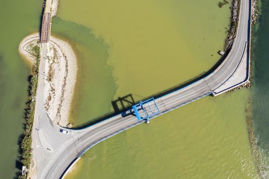 a bridge over a river Mirna at the mouth of a river into the Adriatic Sea, above view, Antenal, Istria, Croatia
