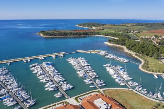 an aerial shot of coastal city Novigrad with boats and yachts in marina, Istria, Croatia