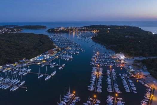An aerial shot at dusk of Verudela peninsula with yachts and boats in Pula, Istria, Croatia