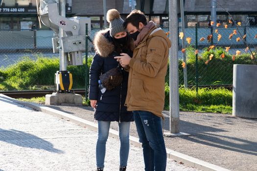 11/20/2020. Prague, Czech Republic. People during quarantine period due to coronavirus at Hradcanska metro stop in Prague. Couple is looking at the phone.