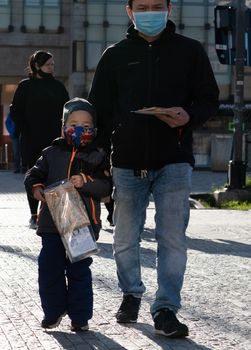 11/20/2020. Prague, Czech Republic. People during quarantine period due to coronavirus at Hradcanska metro stop in Prague. Father and son walking.