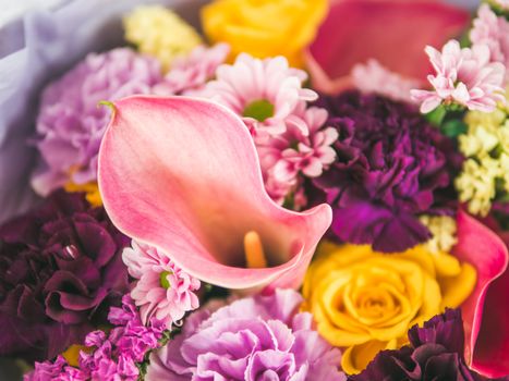 Extreme close up lilac bouquet with arum lily or calla, roses, dianthus, chrysanthemum, limonium, matthiola. Focus on calla. Shallow DOF, copy space