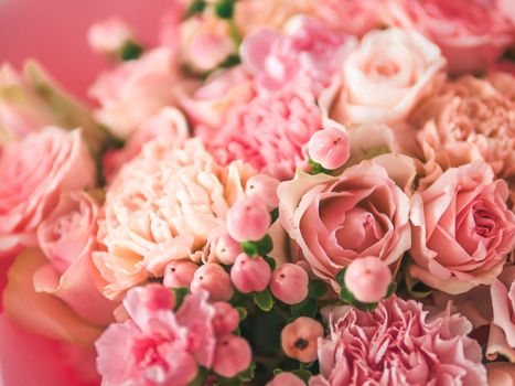 Extreme close up view of nice subtle delicate pink bouquet with roses, dianthus, hypericum, clove. Shallow DOF. Copy space for text.