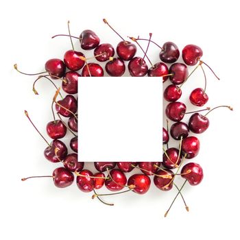 Creative layout with fresh ripe berries. Cherry isolated on white background with white square for copy space. Can use for your design, promo, social media. Top view. Instagram format square.