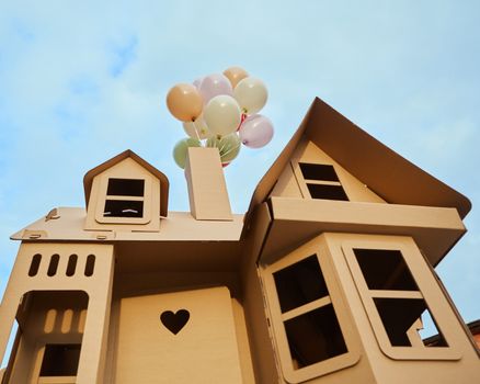 Cardboard playhouse in the backyard for kids. Eco concept.