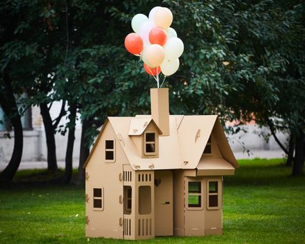 Cardboard playhouse in the backyard for kids. Eco concept.