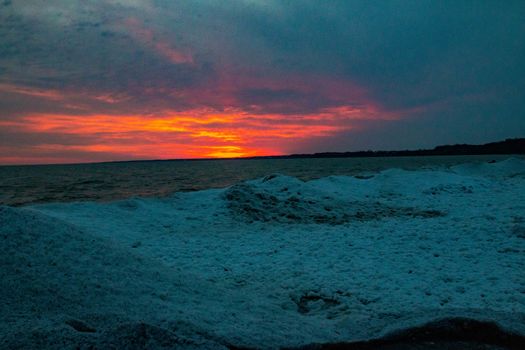 dramatic sunset at Port Stanley beach in the winter in Canada. High quality photo