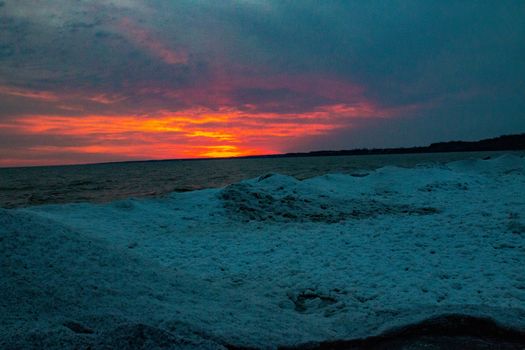 dramatic sunset at Port Stanley beach in the winter in Canada. High quality photo