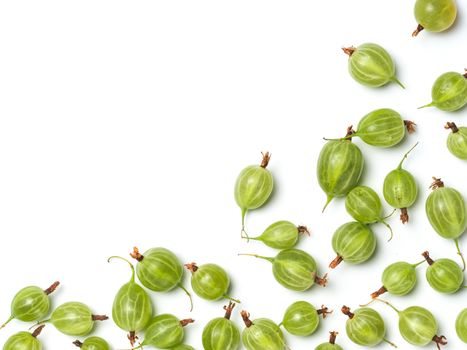 Heap of ripe green gooseberry berries on white background. Creative layout made of organic gooseberries. Isolated on white with clipping path. Top view or flat lay. Copy space for text. Food concept.