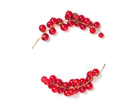 Creative layout - two branches of red currant. Food and diet concept. Top view of ripe red currant with copy space. Isolated on white with clipping path.