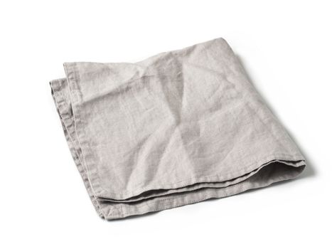 Side view on folded gray linen napkin isolated on white background. light gray linen napkin. Isolated on white with clipping path.