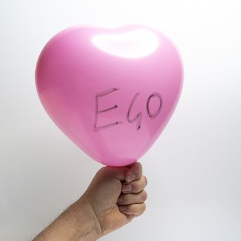 the ego represented with a pink balloon held in the hand