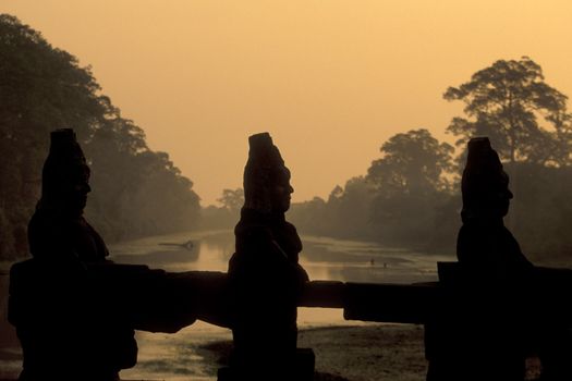 stone face at the Bridge of the south gate to the Angkor Tom city in the Temple City of Angkor near the City of Siem Reap in the west of Cambodia.  Cambodia, Siem Reap, February, 2001
