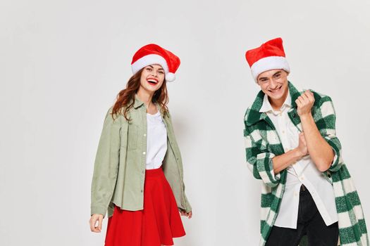 family young couple in christmas hats lifestyle studio emotion. High quality photo