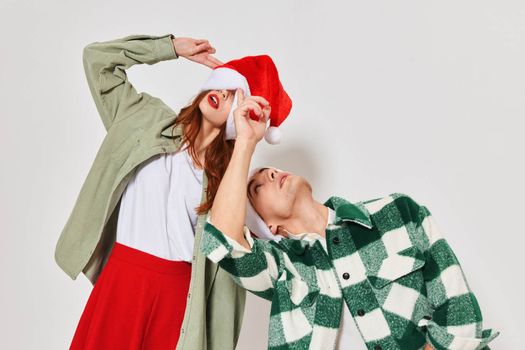 Man and woman Christmas hat Christmas Studio emotions holiday. High quality photo