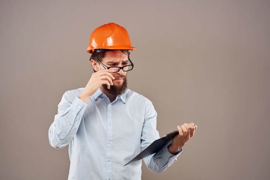 Business man in orange paint documents industry lifestyle beige background. High quality photo