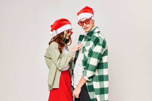 Young couple stand next to each other embrace the New Year holiday togetherness. High quality photo