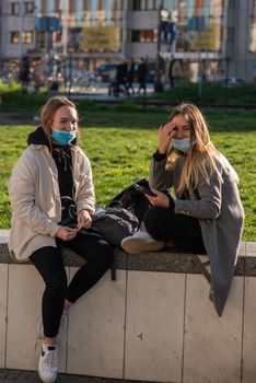 11-22-2020. Prague, Czech Republic. People during quarantine period due to coronavirus (COVID-19) at Hradcanska metro stop in Prague 6.Girlfriends talking.