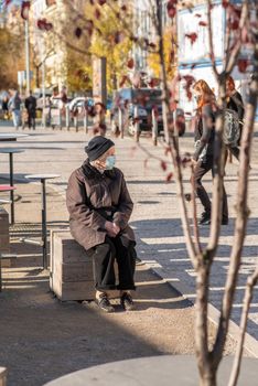 11-22-2020. Prague, Czech Republic. People during quarantine period due to coronavirus (COVID-19) at Hradcanska metro stop in Prague 6. Old women sitting.