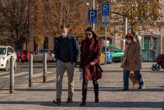 11-22-2020. Prague, Czech Republic. People during quarantine period due to coronavirus (COVID-19) at Hradcanska metro stop in Prague 6. Couple walking