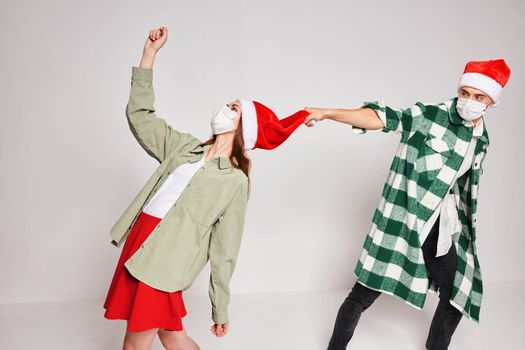 young couple christmas hats holiday emotions fun together. High quality photo