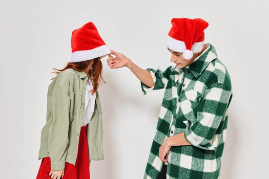 man peeping under the hat woman new year holiday curiosity friendship. High quality photo