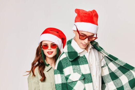 Man and woman New Years Style Holiday studio close-up sunglasses. High quality photo