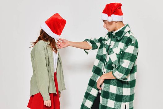 Man and woman New Year clothes emotion holiday Christmas Santa hat. High quality photo