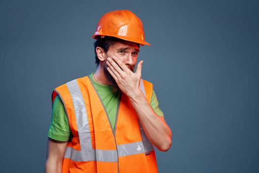 Man in working uniform to professionals construction lifestyle blue background. High quality photo