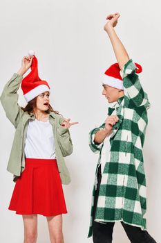 Cheerful young couple celebrating New Years with hands raised up. High quality photo
