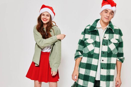 cheerful young couple wearing christmas hats christmas holiday fun fashion. High quality photo