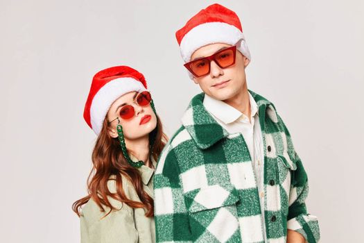 young couple wearing black glasses christmas hats together romance holiday. High quality photo