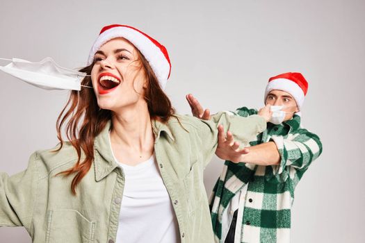 Cheerful woman and man medical masks Christmas holidays fun emotions. High quality photo