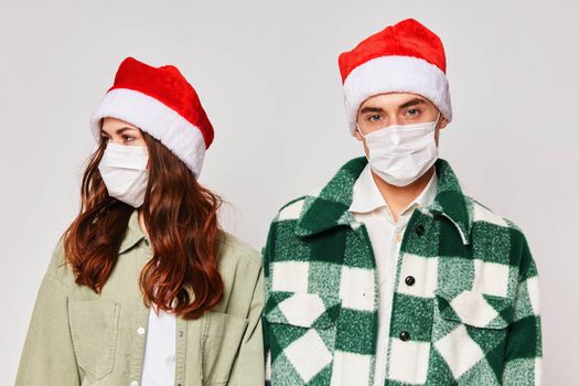 Man and woman in medical masks New Years holiday friendship together. High quality photo