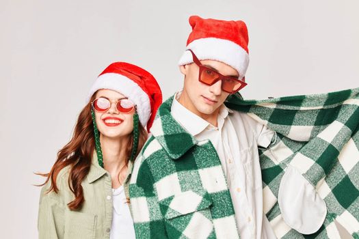 cheerful man and woman wearing sunglasses new year winter holiday friendship fun. High quality photo