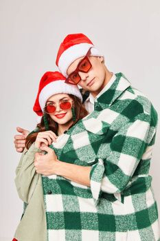 A man hugs a woman young couple New Years sunglasses holiday friendship. High quality photo