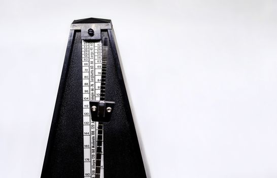 Detail of the pendulum of a classic metronome. Rhythm measurement tool. Mechanical movement without electricity