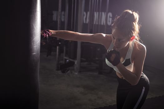 Fitness girl doing  boxing training in sport gym